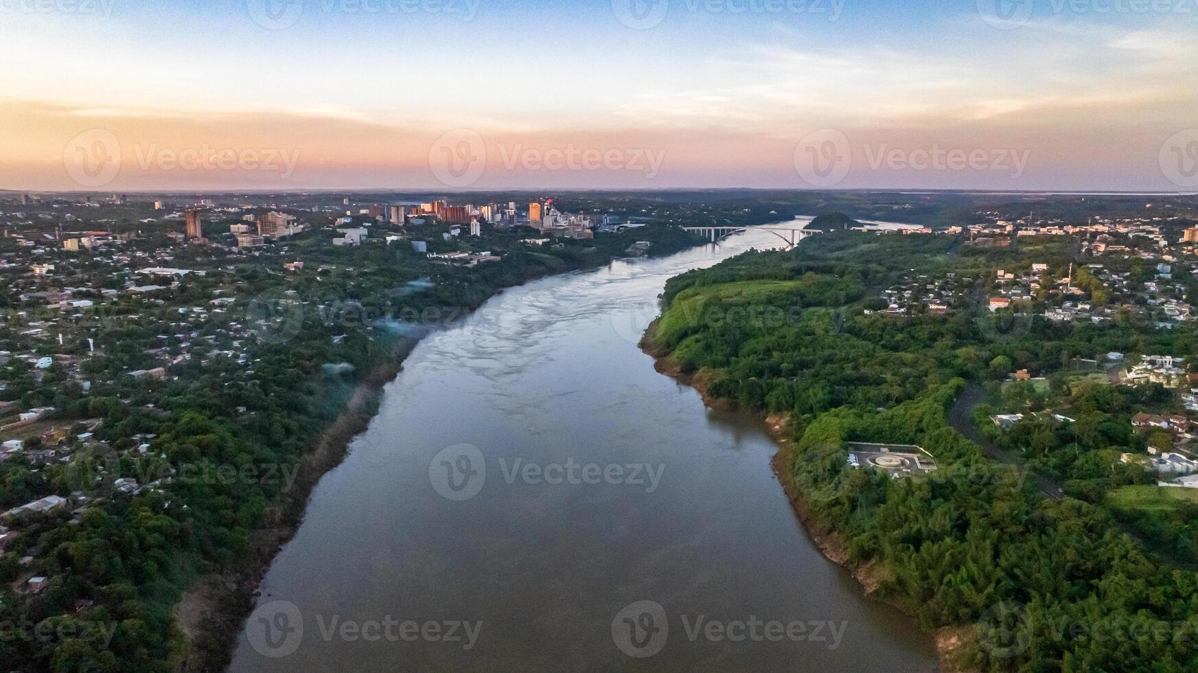 Border between Brazil and Paraguay and connects Foz do Iguacu to Ciudad del Este. Ponte da Amizade in Foz do Iguacu. Aerial view of the Friendship Bridge with Parana river. photo
