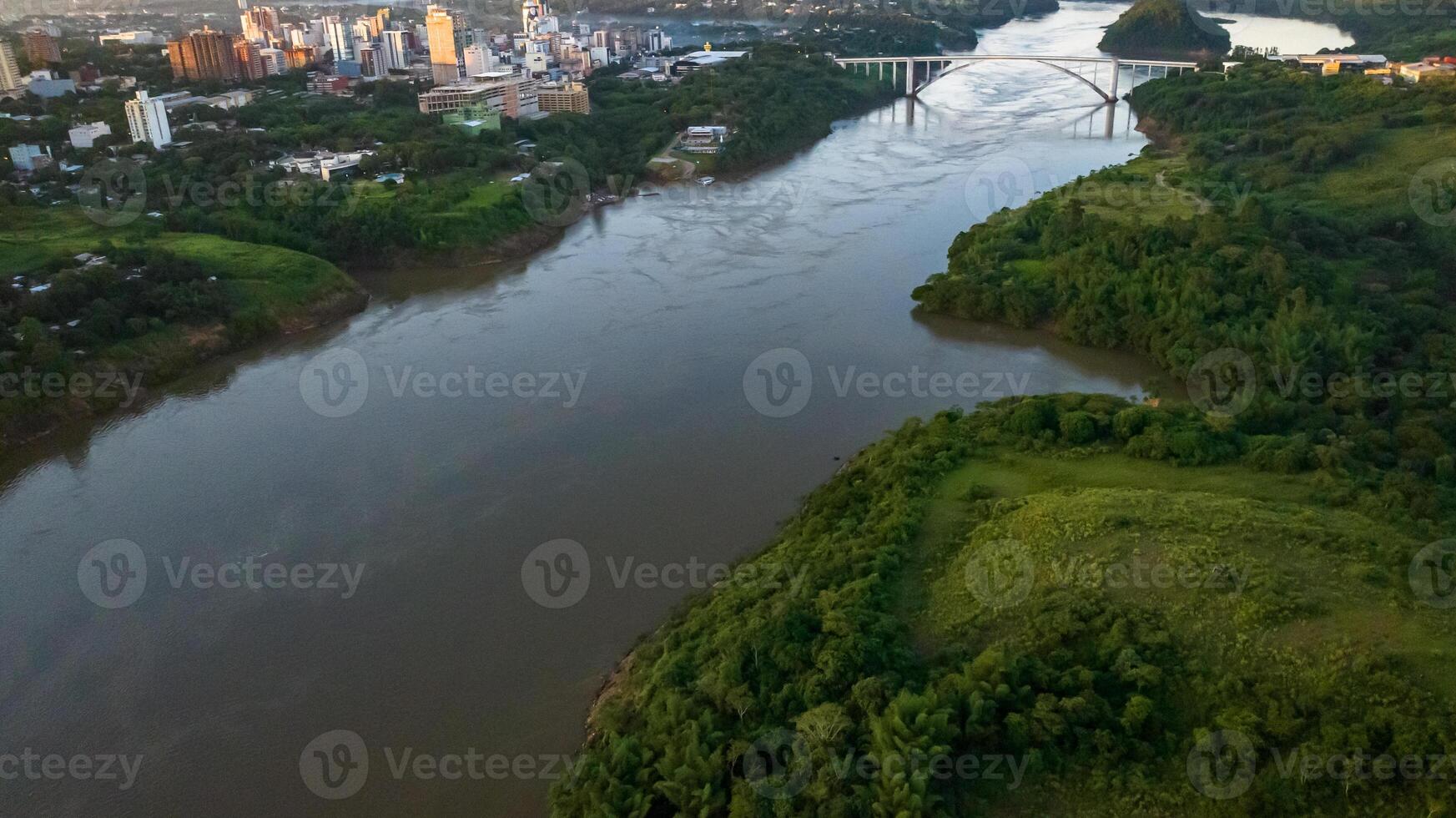 Border between Brazil and Paraguay and connects Foz do Iguacu to Ciudad del Este. Ponte da Amizade in Foz do Iguacu. Aerial view of the Friendship Bridge with Parana river. photo