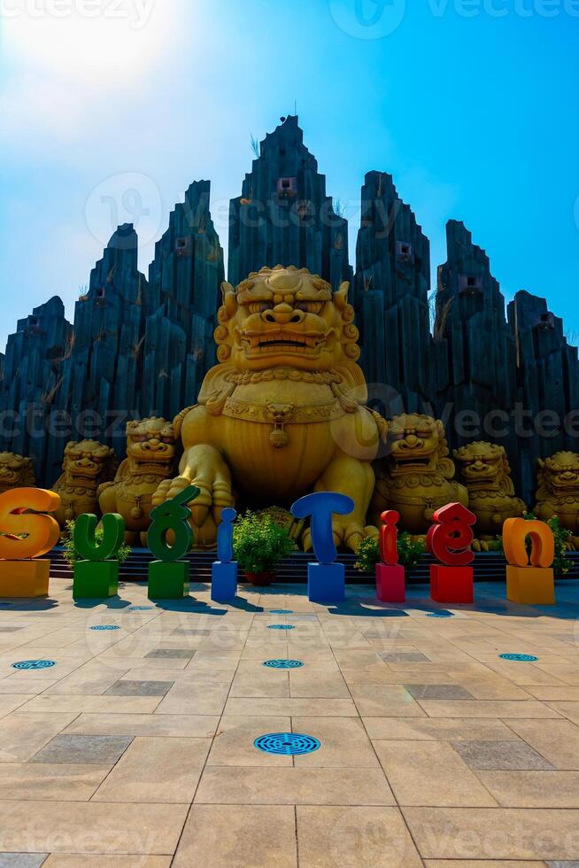 A Big Statue Guardian dog at Suoi Tien park in Ho Chi Minh wide shot photo