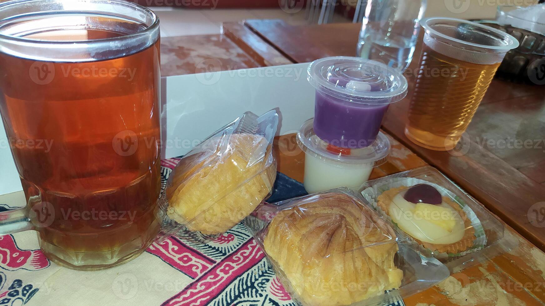 Indonesia Cakes, pudding and sweet tea on the table photo