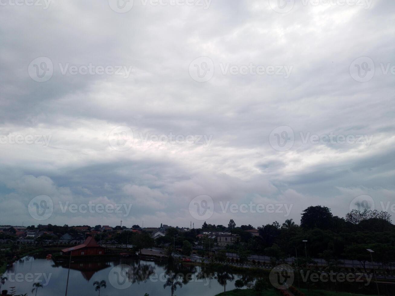 View of the sky with bright clouds on the lake photo