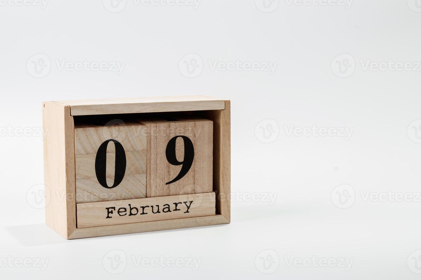 Wooden calendar February 09 on a white background photo