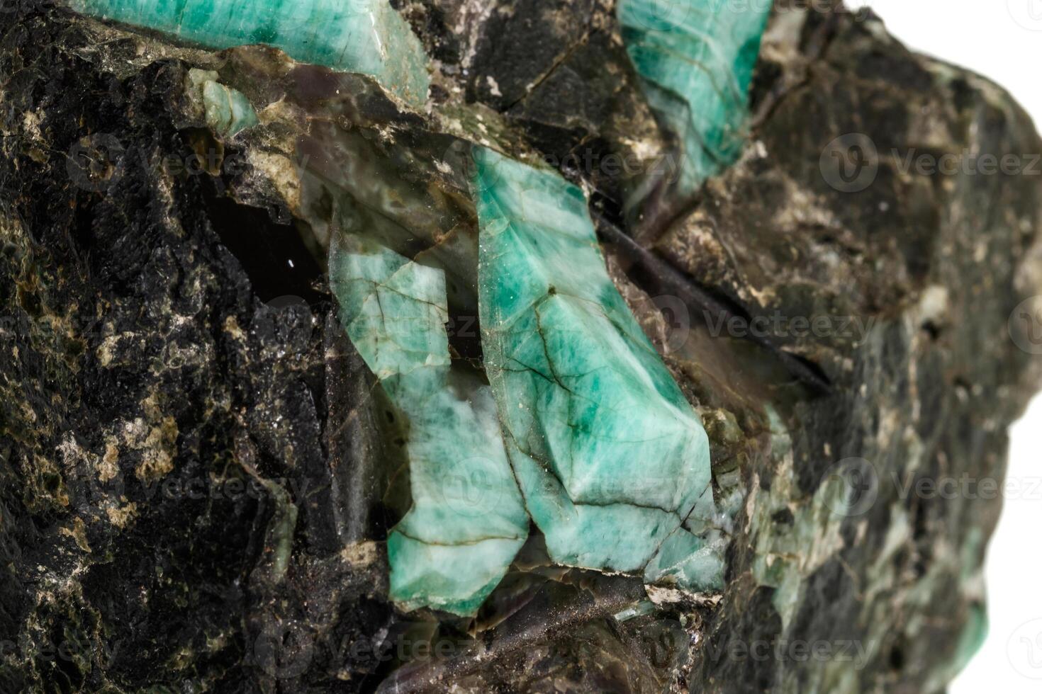 Macro emerald stone mineral in rock on white background photo