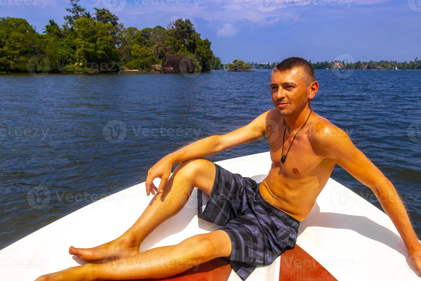 Boat safari mangrove jungle man male tourist River Bentota Beach Sri Lanka. photo