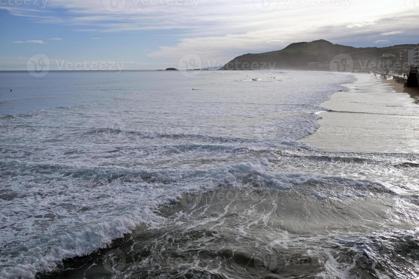 Waves coming in during sunrise in Zarautz, Spain photo