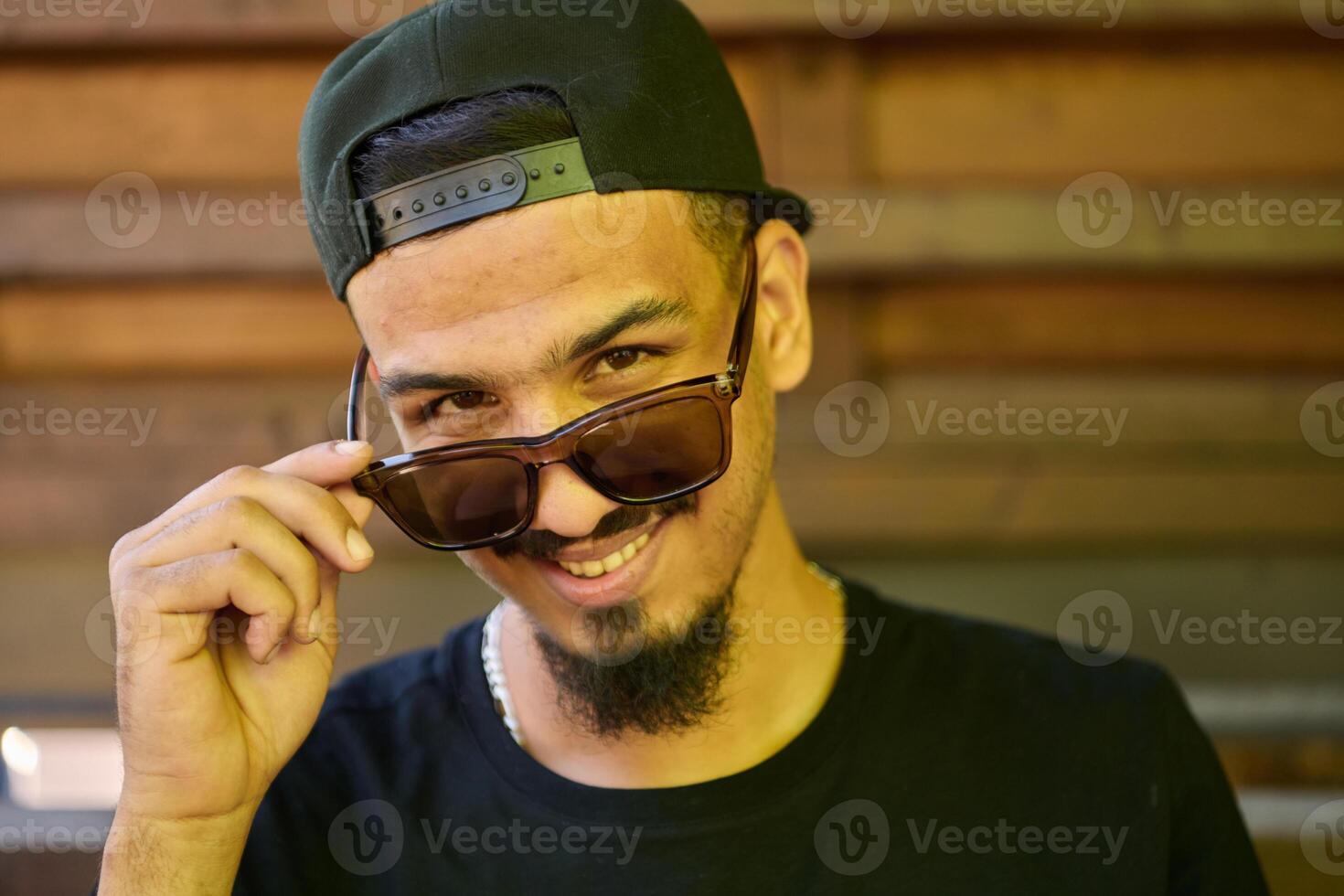 Close Up Portrait of Smiling Sudanese Teenager with Broad Smile, Chin, and Cap photo