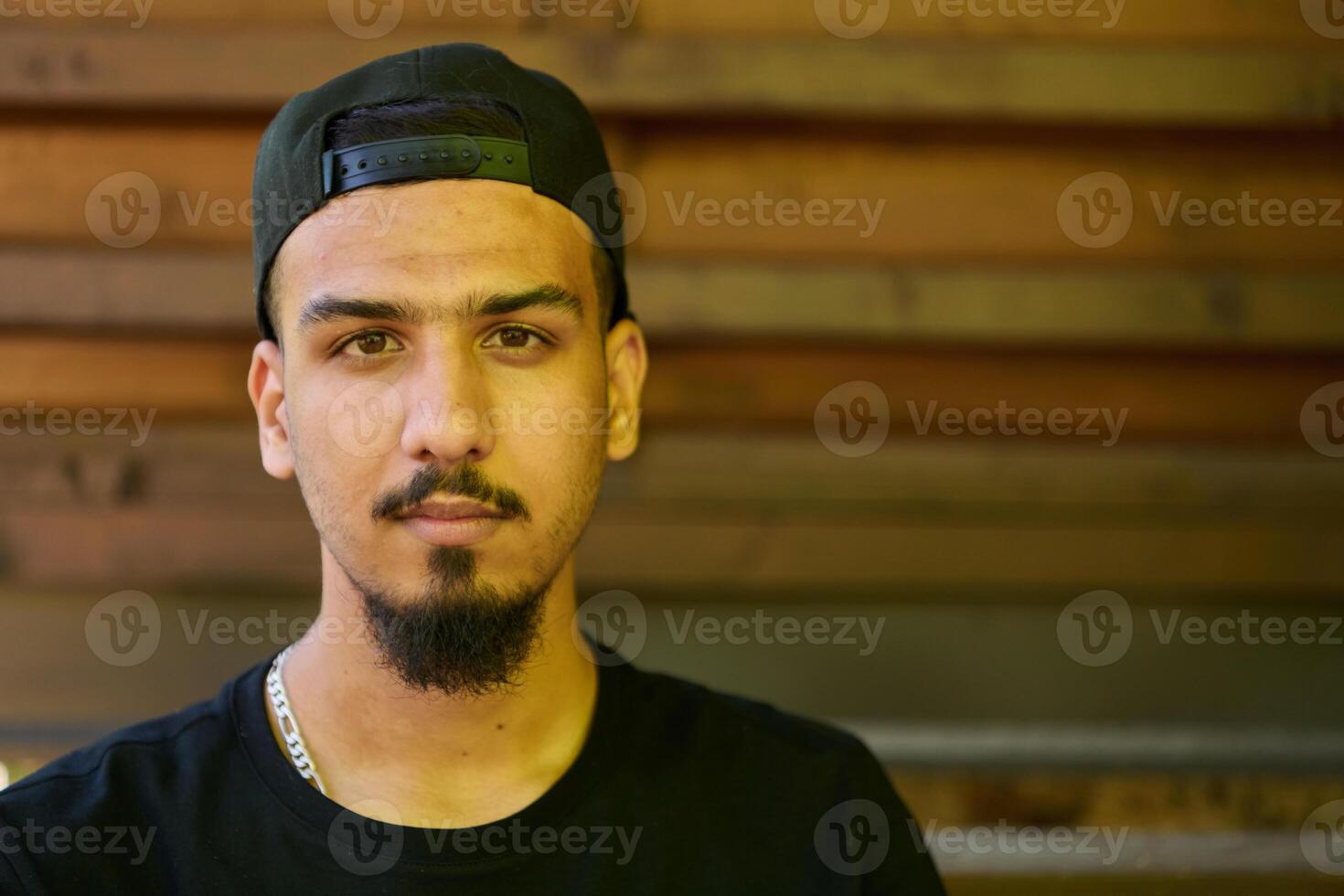 Close Up Portrait of Smiling Sudanese Teenager with Broad Smile, Chin, and Cap photo