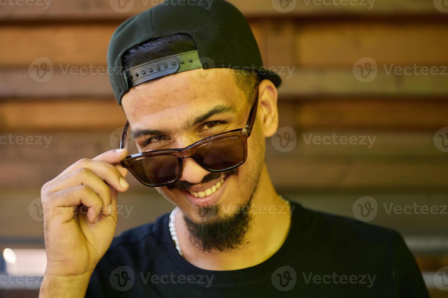 Close Up Portrait of Smiling Sudanese Teenager with Broad Smile, Chin, and Cap photo
