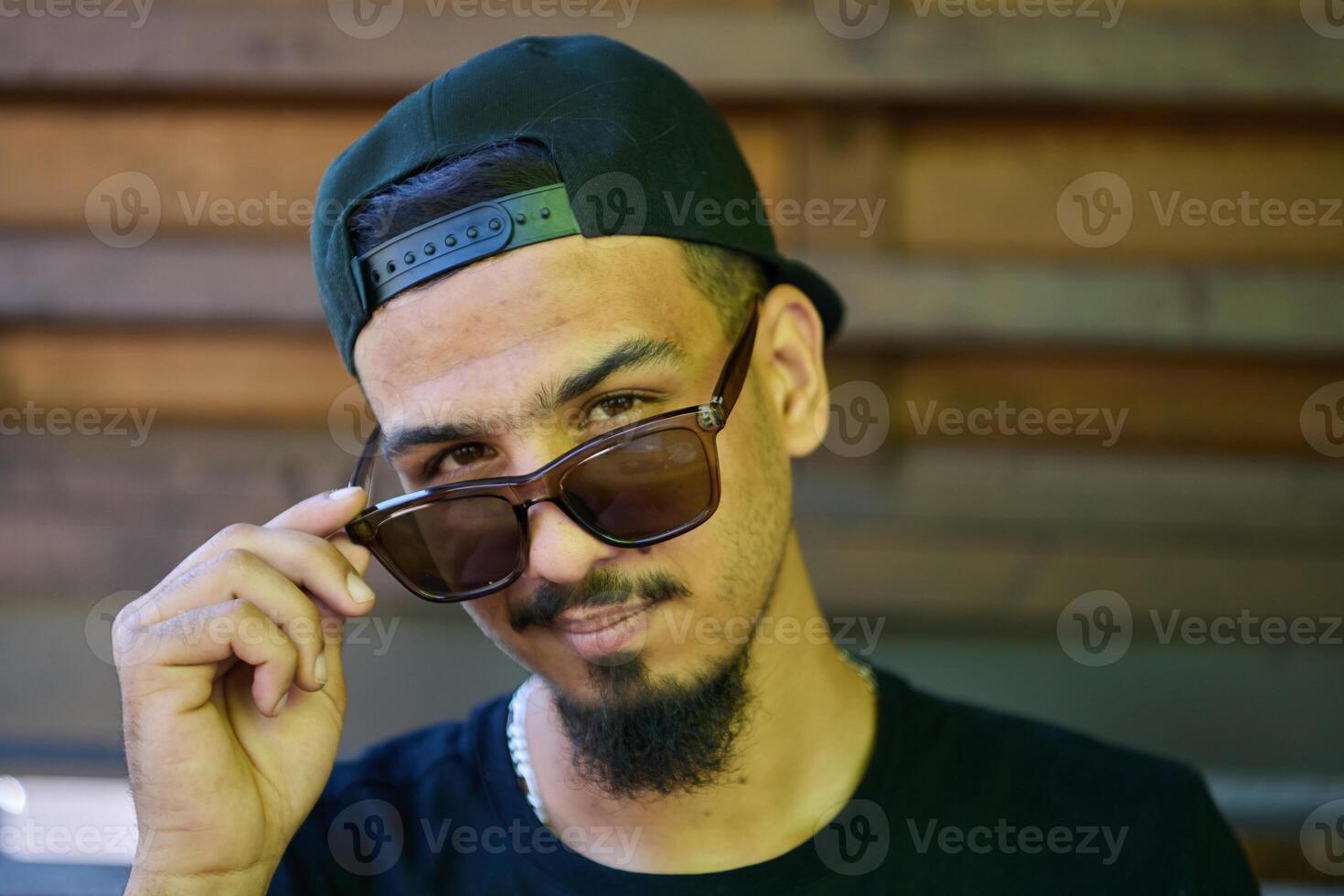 Close Up Portrait of Smiling Sudanese Teenager with Broad Smile, Chin, and Cap photo