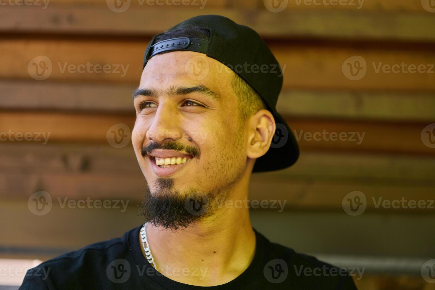 Close Up Portrait of Smiling Sudanese Teenager with Broad Smile, Chin, and Cap photo