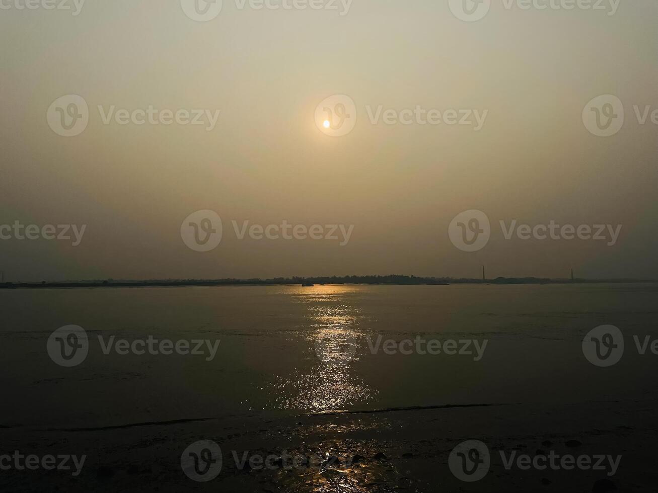 sunset view of ocean at the edge of beach photo
