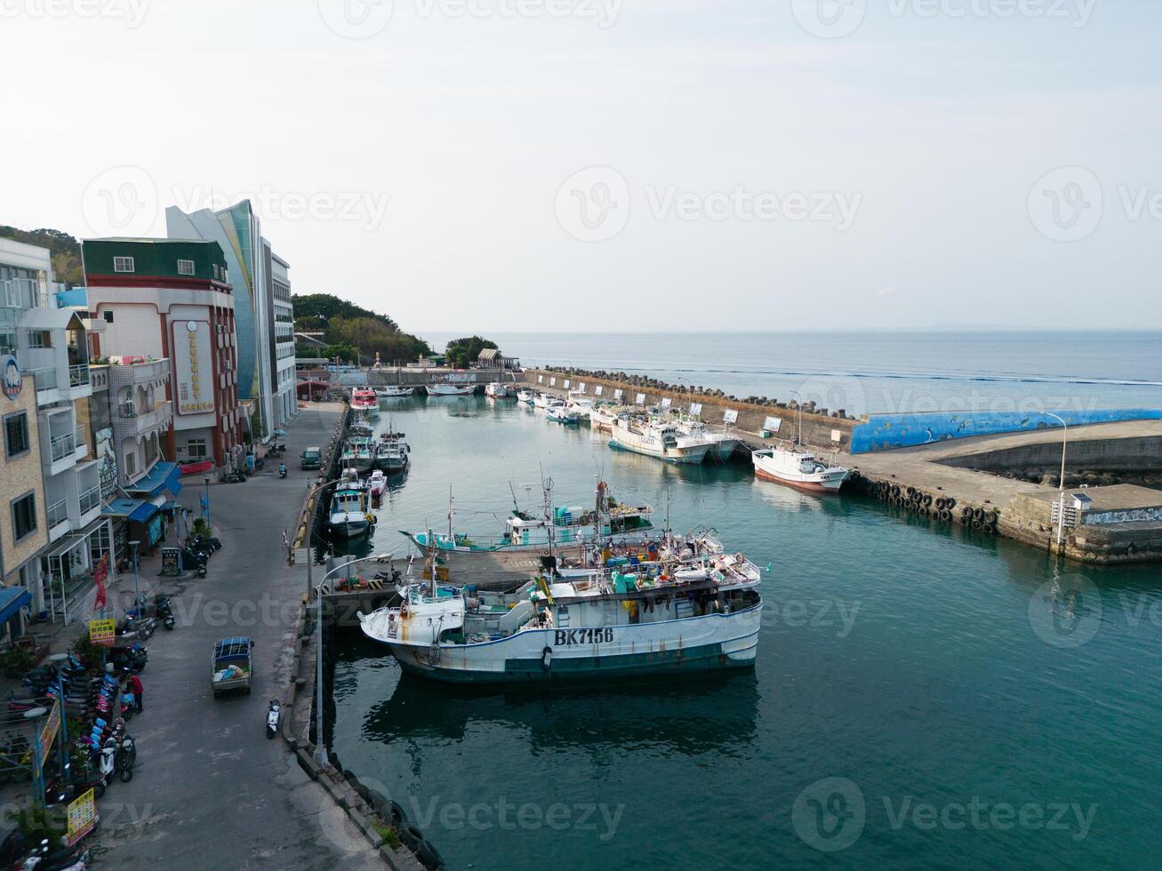 Harbor of Xiaoliuqiu Taiwan, Peaceful City Island, Blue Sea, and Fishing Ships photo