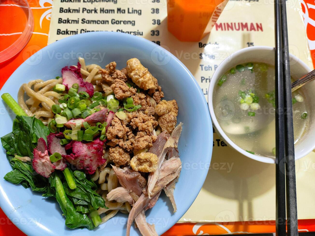 Delicious Asian Noodle Bowl with Fresh Greens and Savory Meat photo