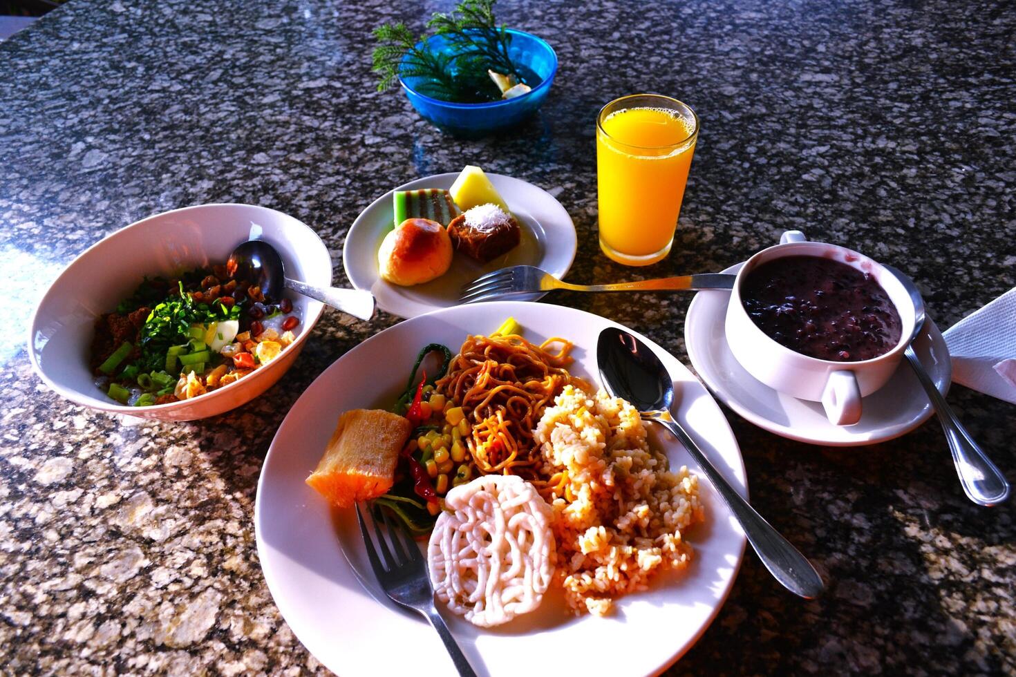 Noodles, poridges, cakes and drink for breakfast on marmer table photo