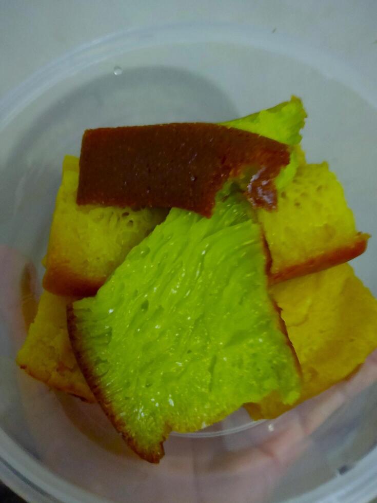 Sliced sweet and springy cakes in transparent container photo