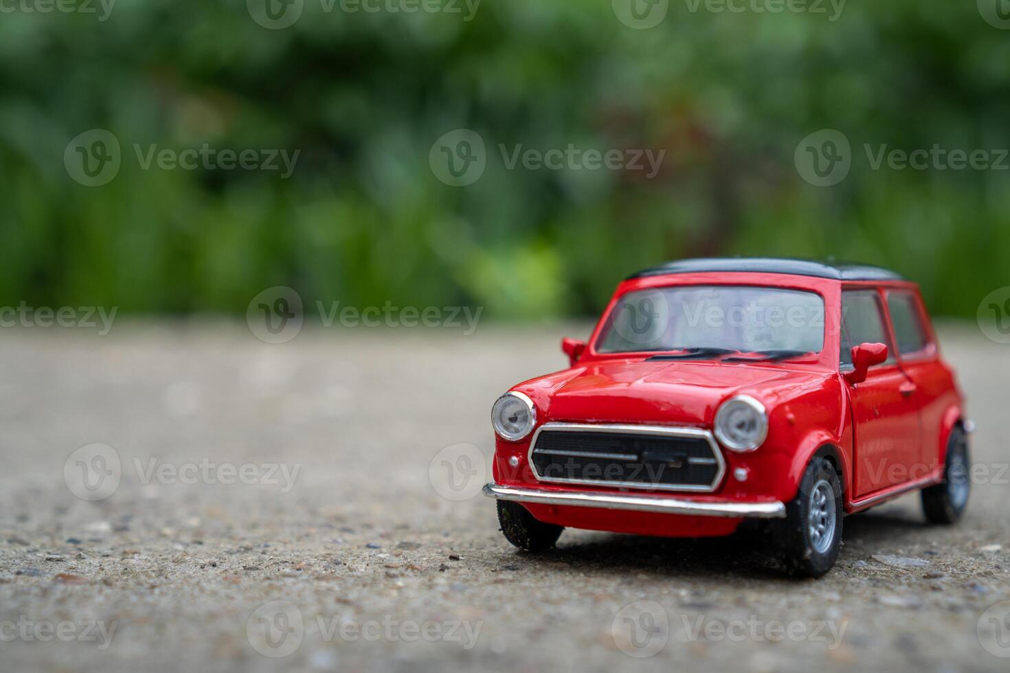 A close-up picture of a retro red toy car photo