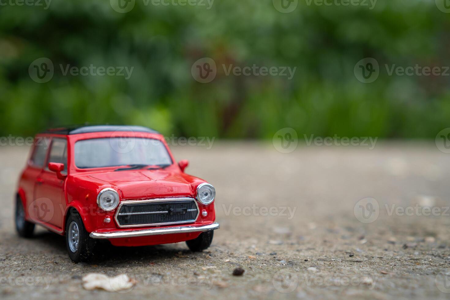 A close-up picture of a retro red toy car photo