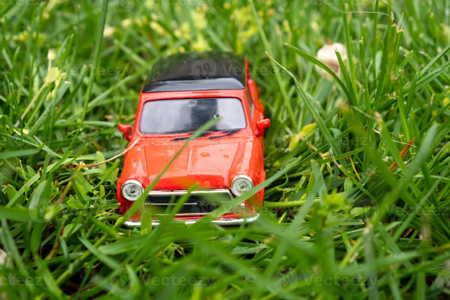 A close-up picture of a retro red toy car photo