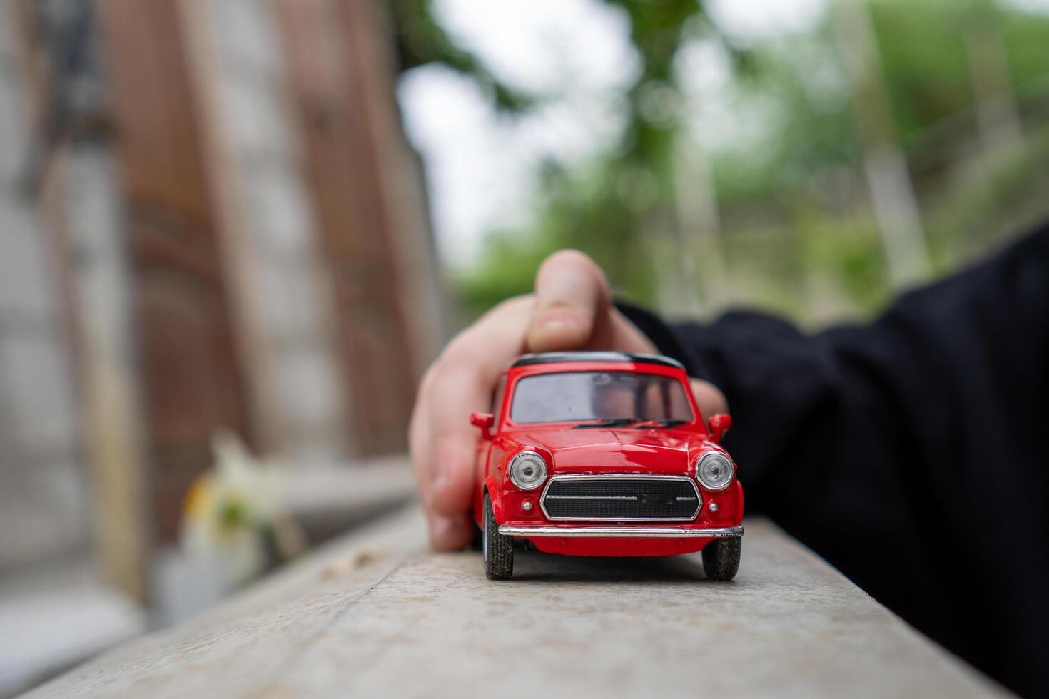 A close-up picture of a retro red toy car photo
