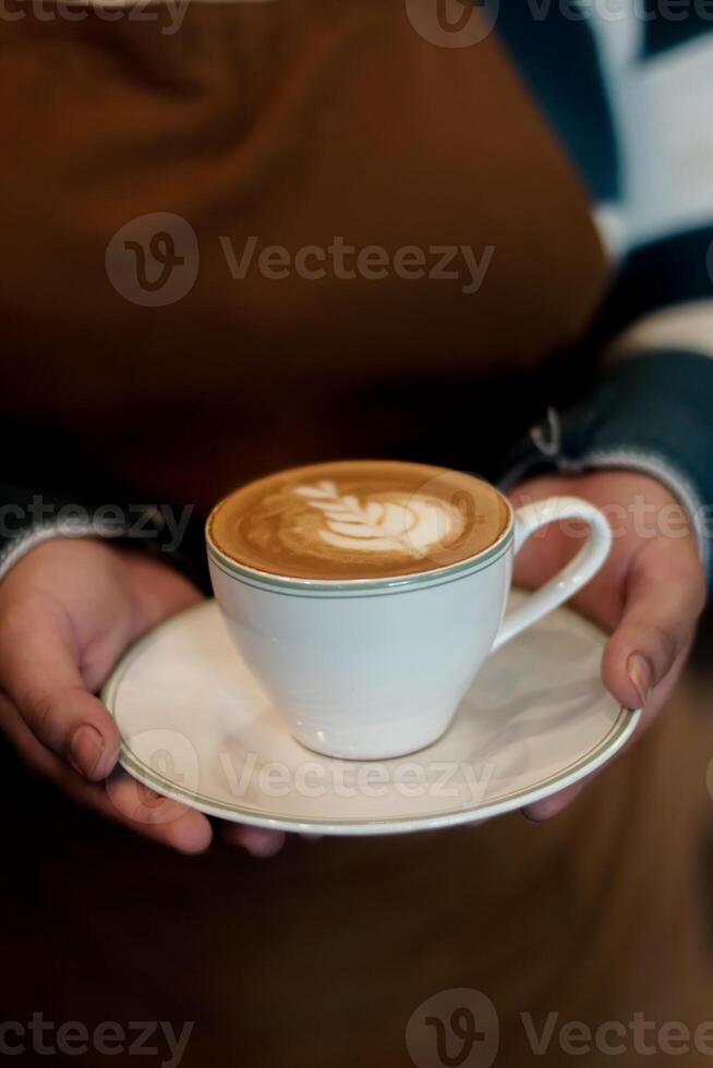 Cup of Coffee Latte in Hands photo