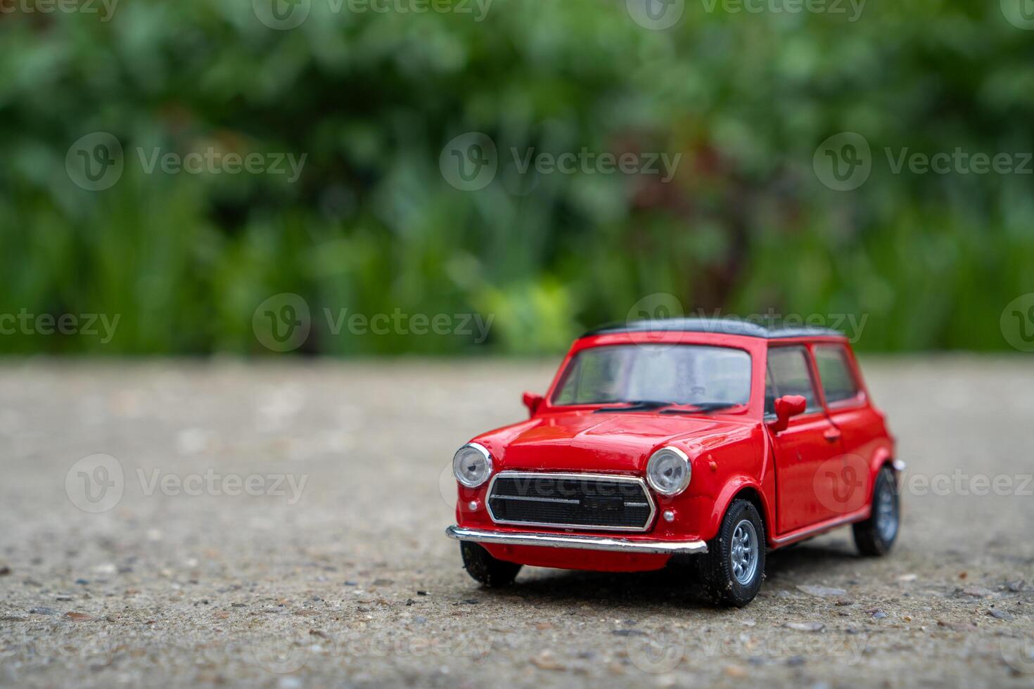 A close-up picture of a retro red toy car photo