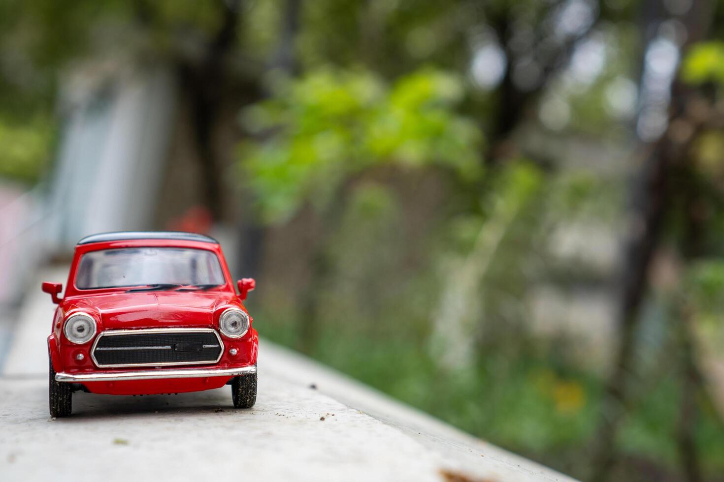 A close-up picture of a retro red toy car photo