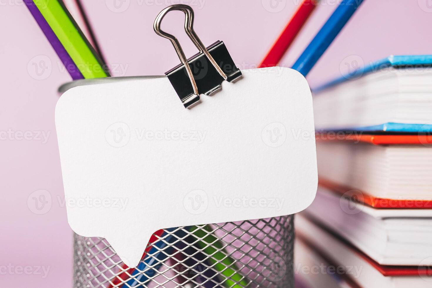 white sticker, books, notepad and pensil on workplace. Mock up in copy space office purple background. It is important not to forget the note photo