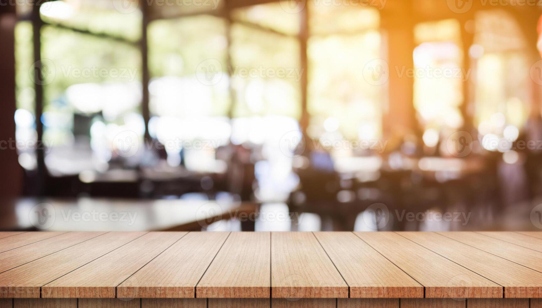 Empty wooden table top with lights bokeh on blur restaurant background. photo