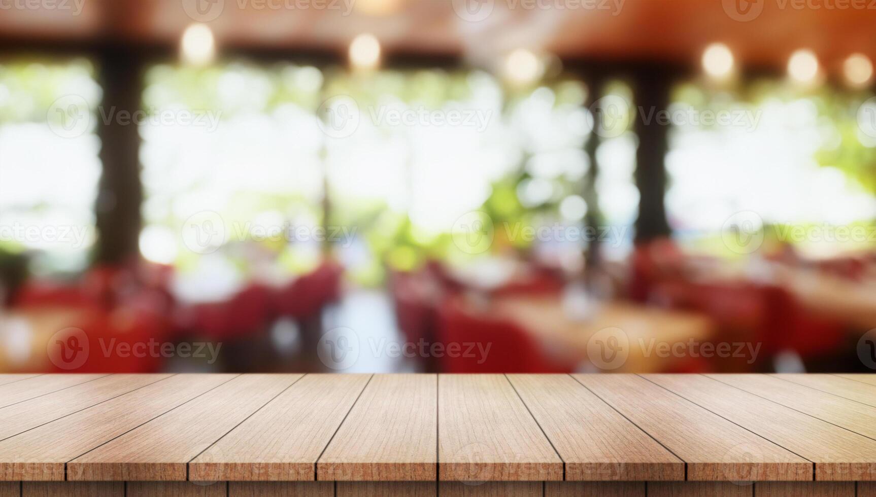 Empty wooden table top with lights bokeh on blur restaurant background. photo