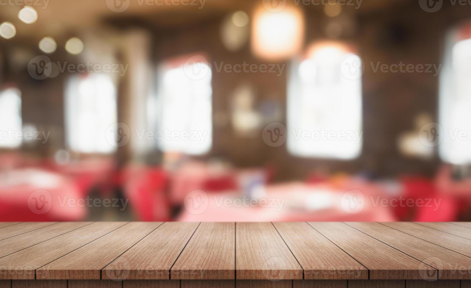 Empty wooden table top with lights bokeh on blur restaurant background photo