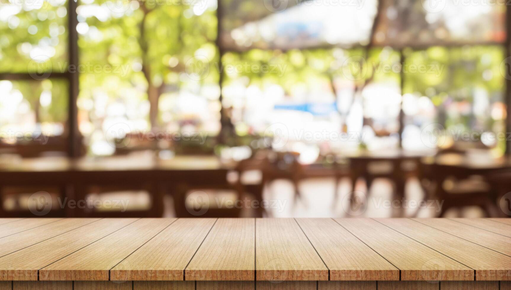 Empty wooden table top with lights bokeh on blur restaurant background. photo