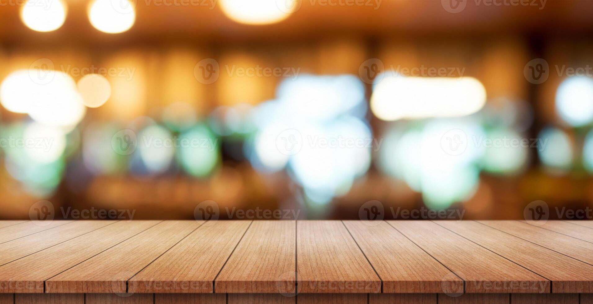 Empty wooden table top with lights bokeh on blur restaurant background. photo