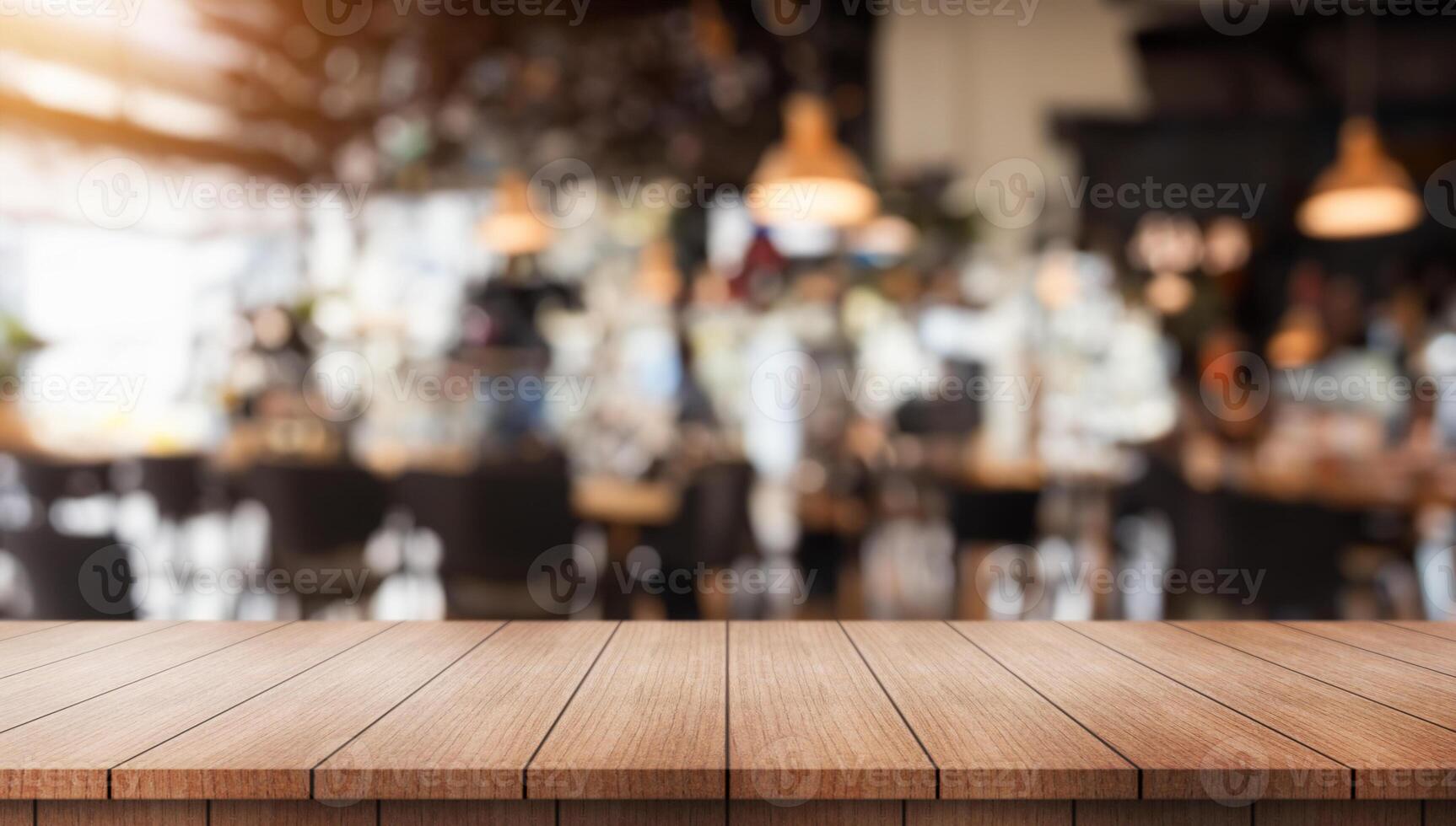 Empty wooden table top with lights bokeh on blur restaurant background. photo