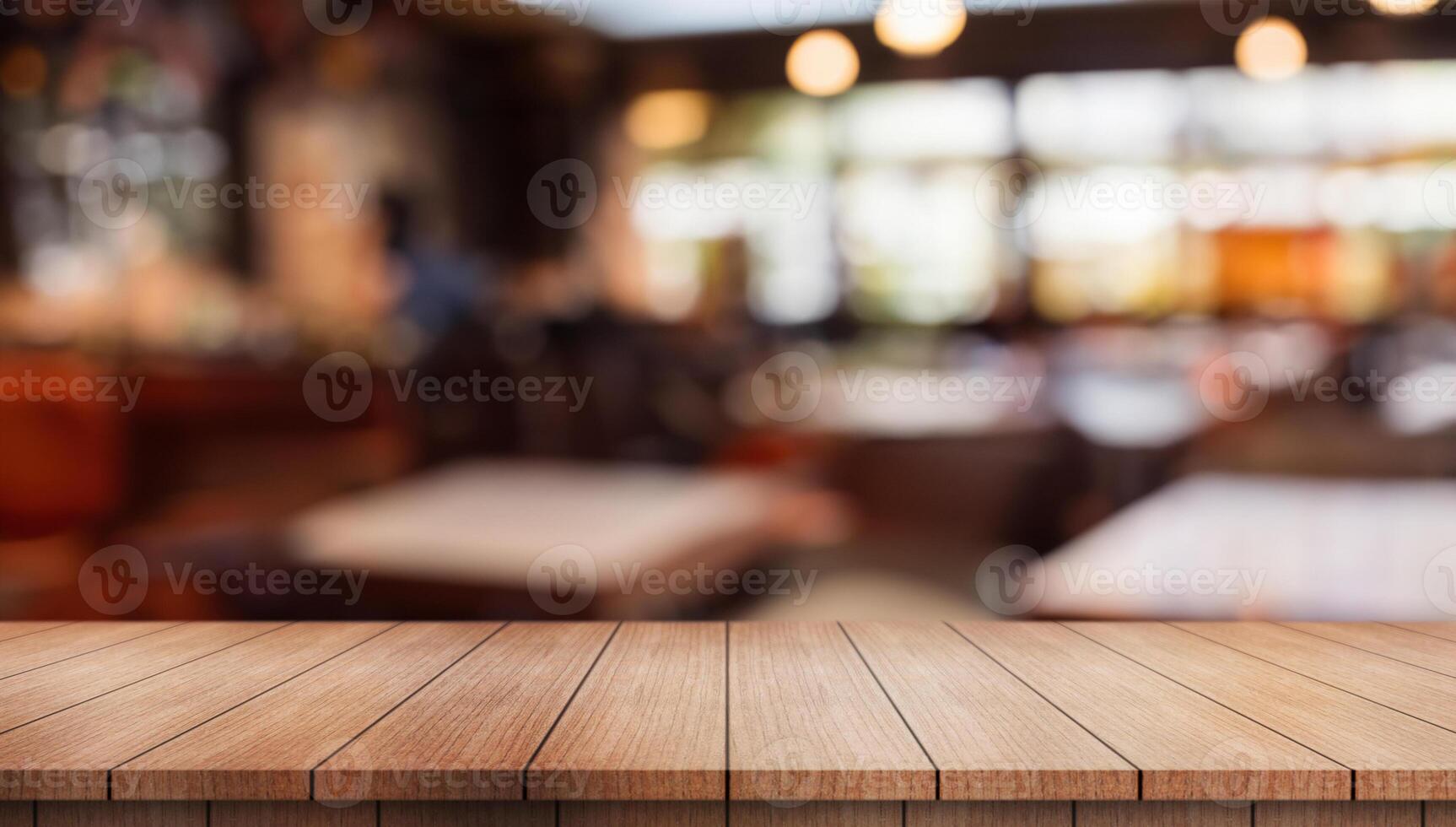 Empty wooden table top with lights bokeh on blur restaurant background. photo