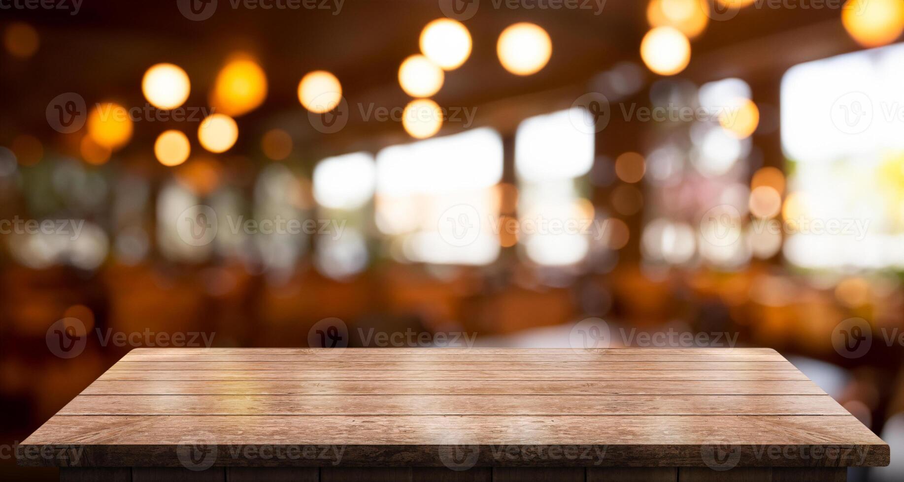 Empty wooden table top with lights bokeh on blur restaurant background photo