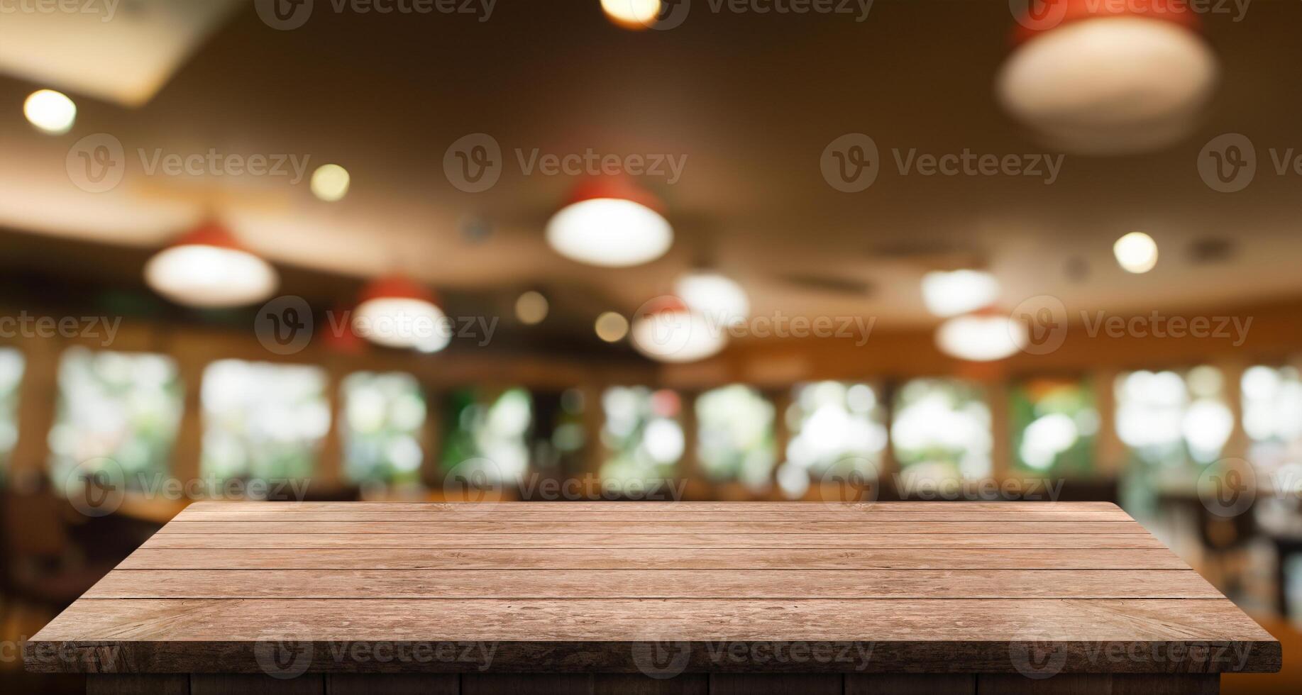 Empty wooden table top with lights bokeh on blur restaurant background photo