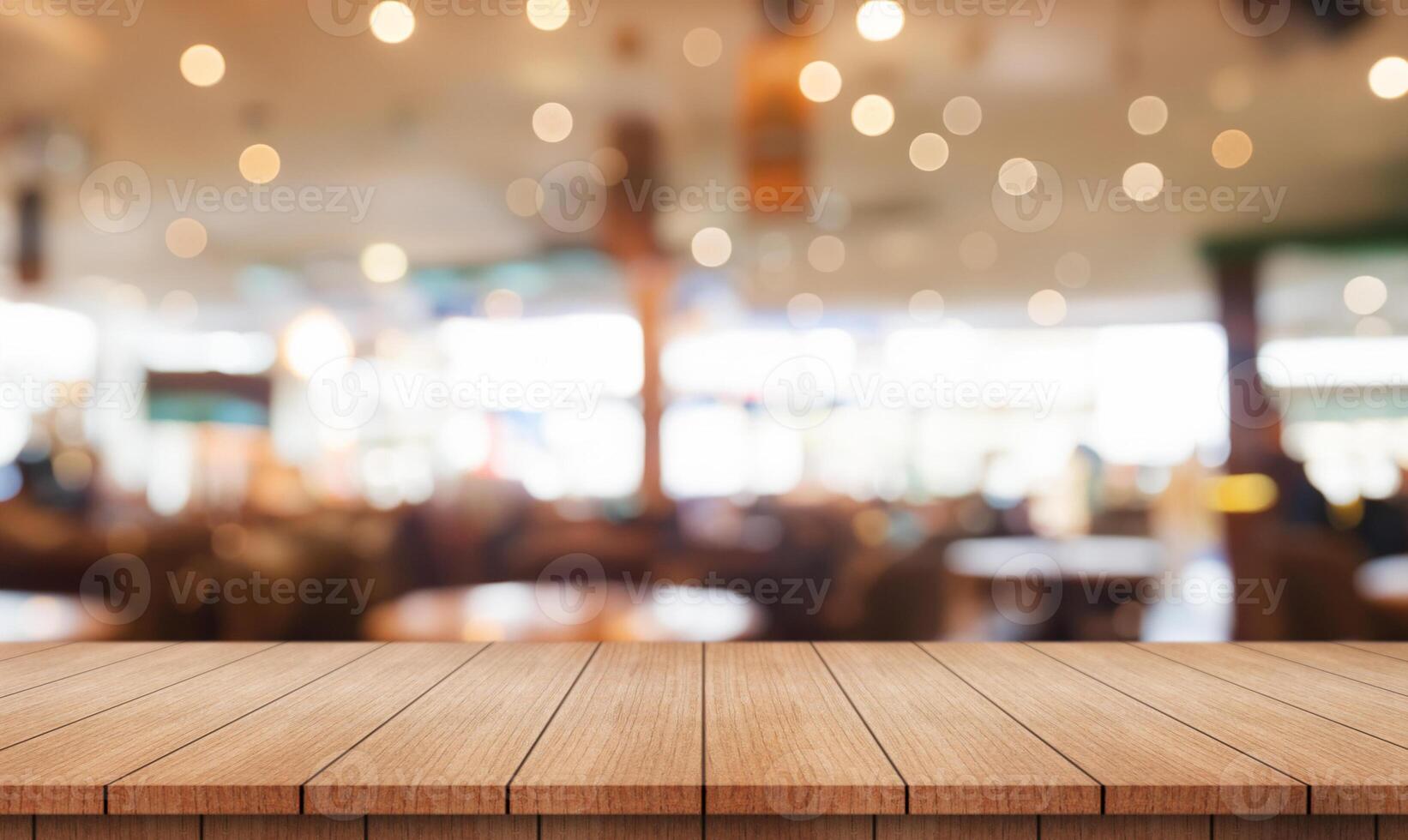 Empty wooden table top with lights bokeh on blur restaurant background. photo
