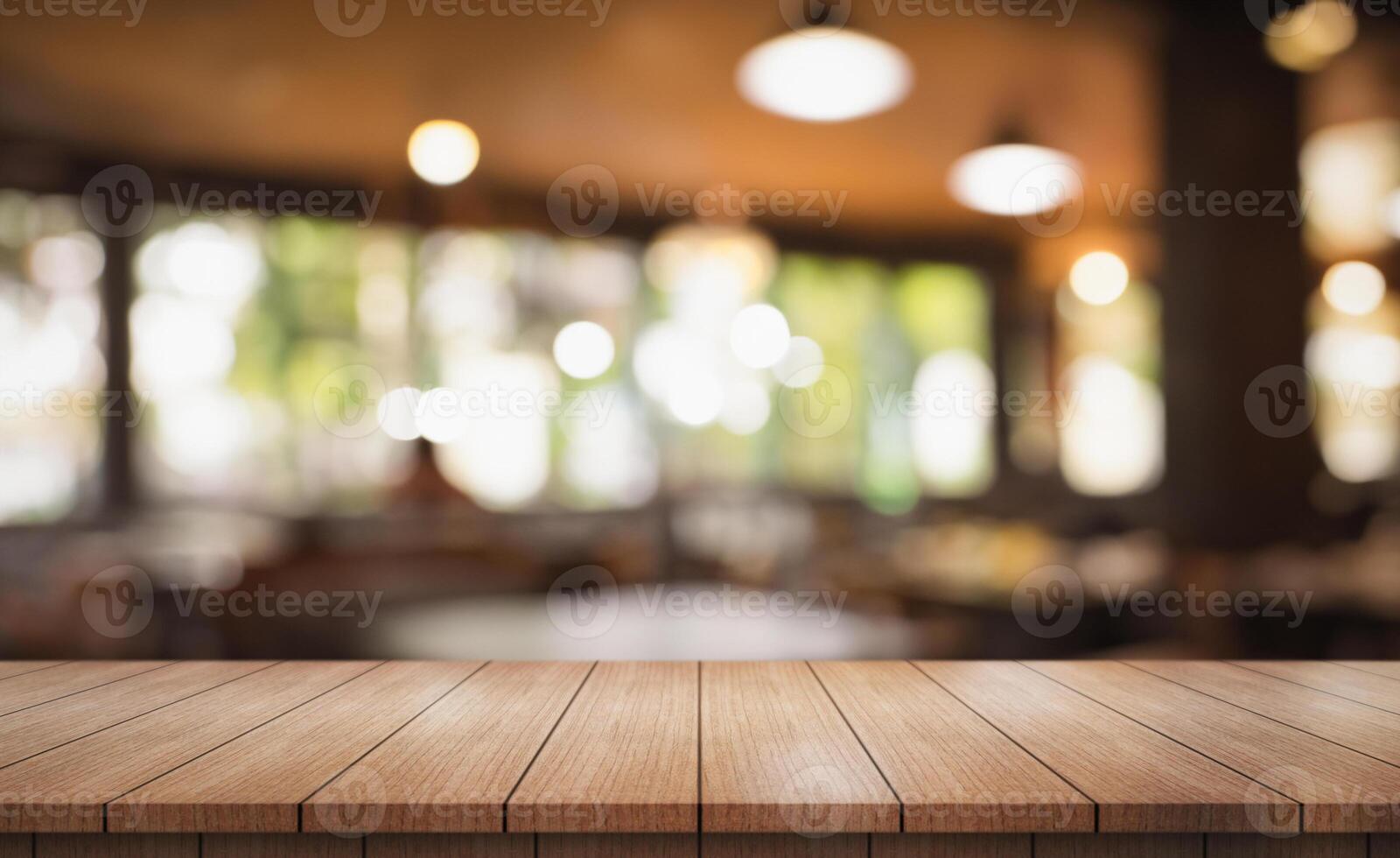 Empty wooden table top with lights bokeh on blur restaurant background photo