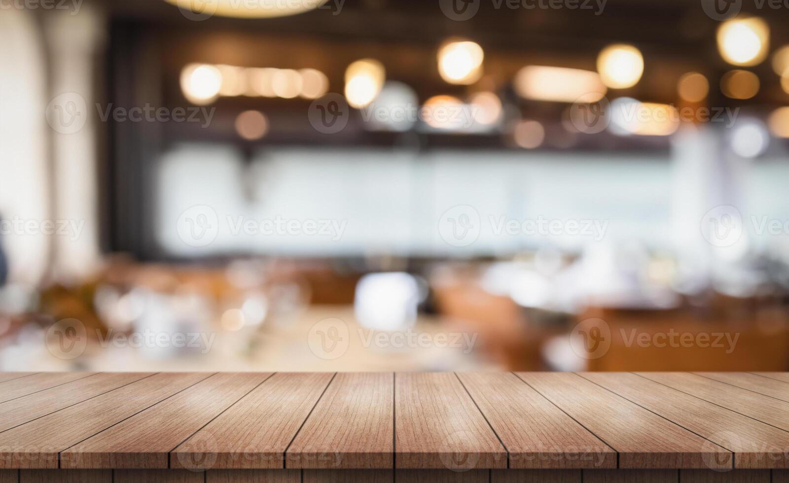 Empty wooden table top with lights bokeh on blur restaurant background photo