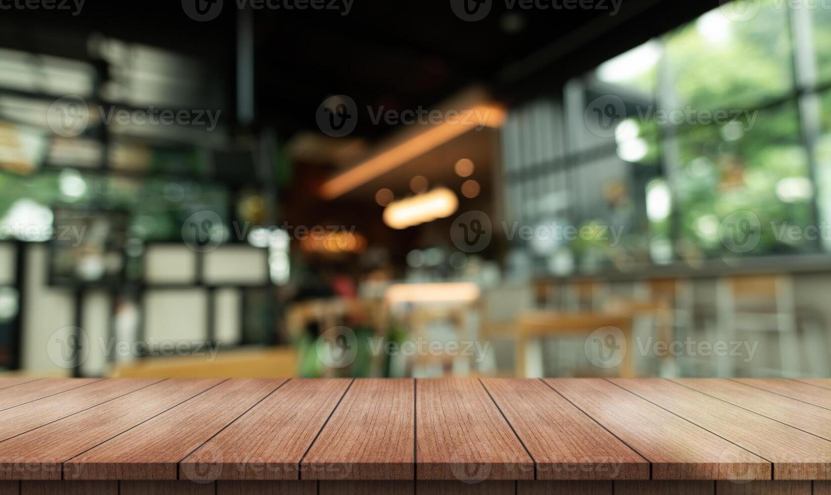 Empty wooden table top with lights bokeh on blur restaurant background photo