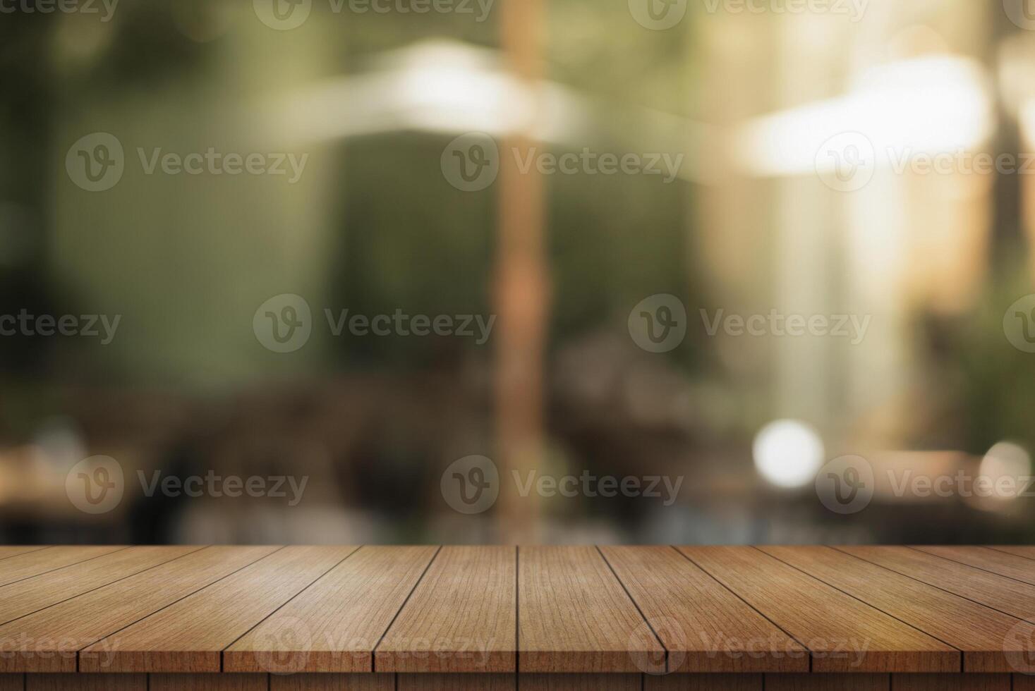 Empty wooden table top with lights bokeh on blur restaurant background. photo