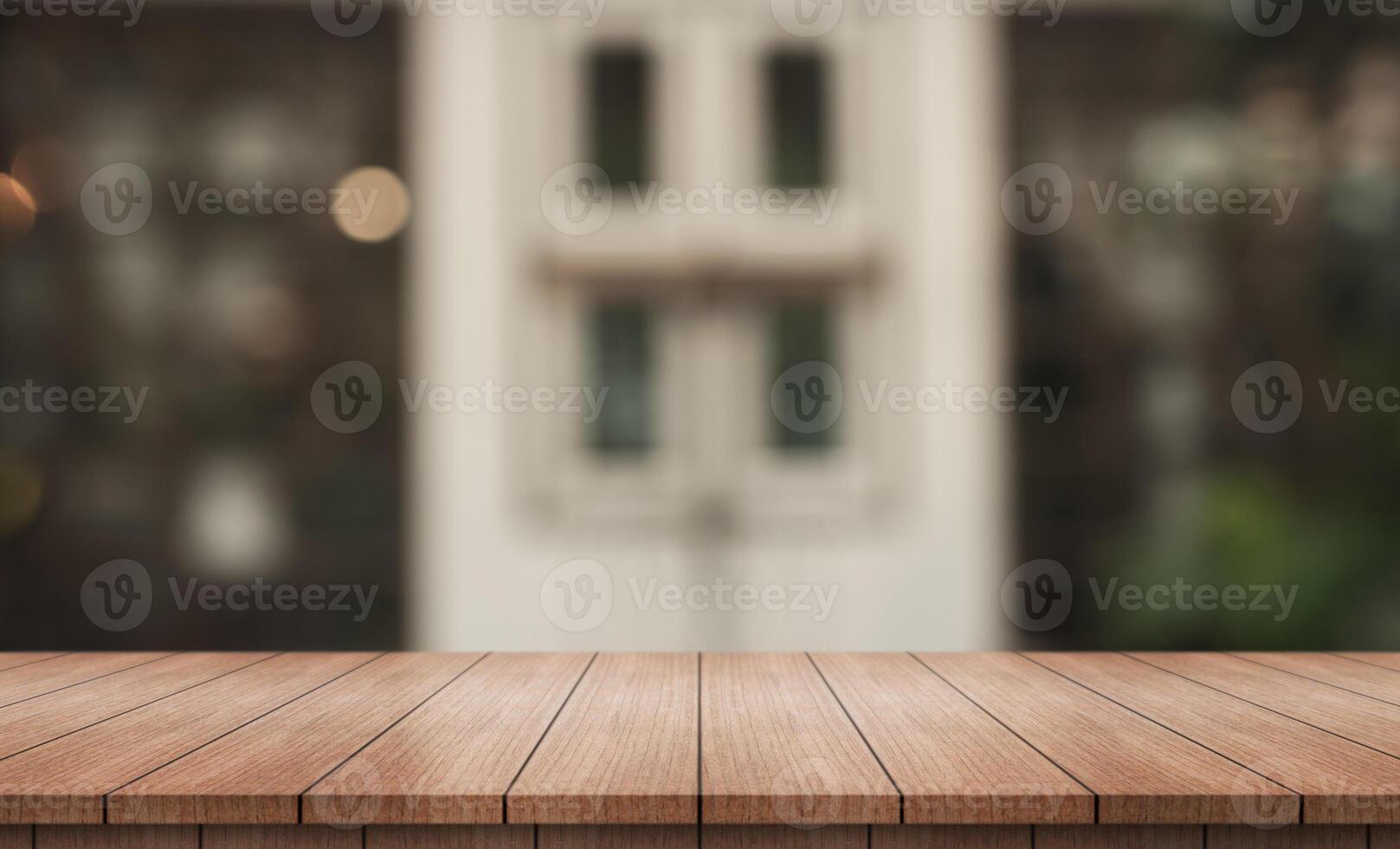 Empty wooden table top with lights bokeh on blur restaurant background. photo