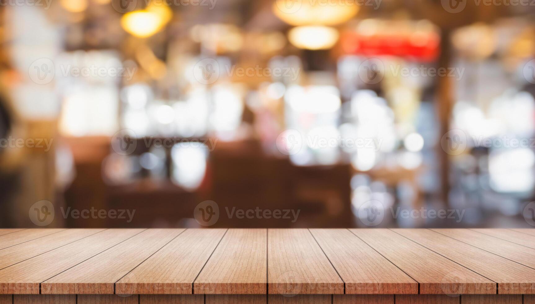 Empty wooden table top with lights bokeh on blur restaurant background. photo
