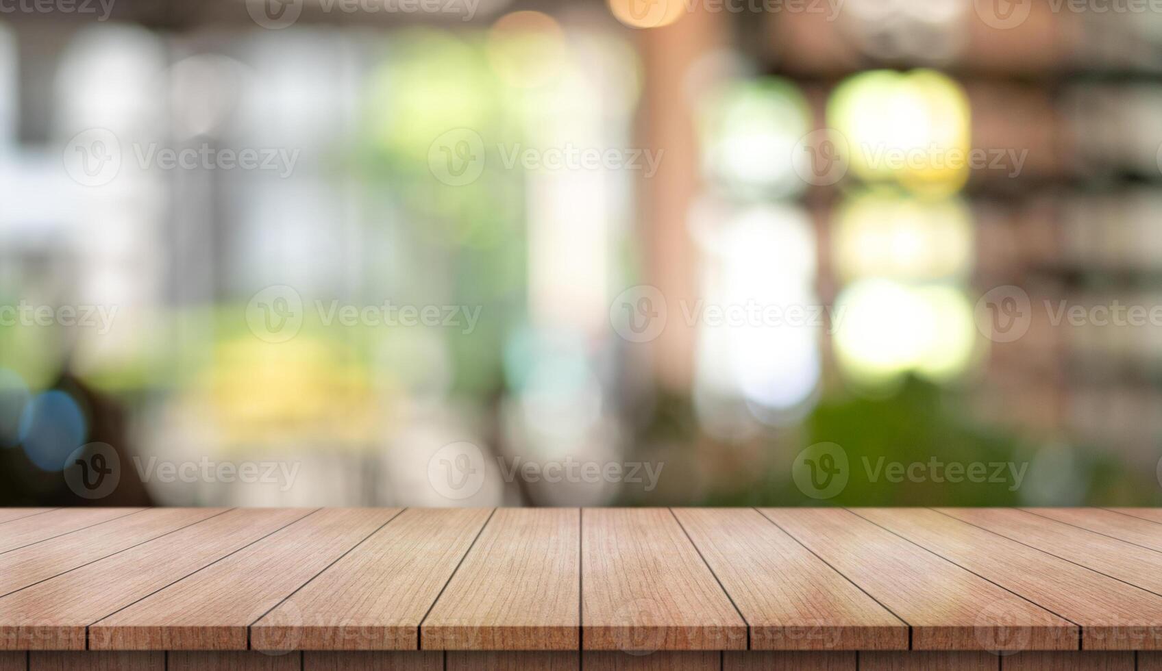 Empty wooden table top with lights bokeh on blur restaurant background. photo