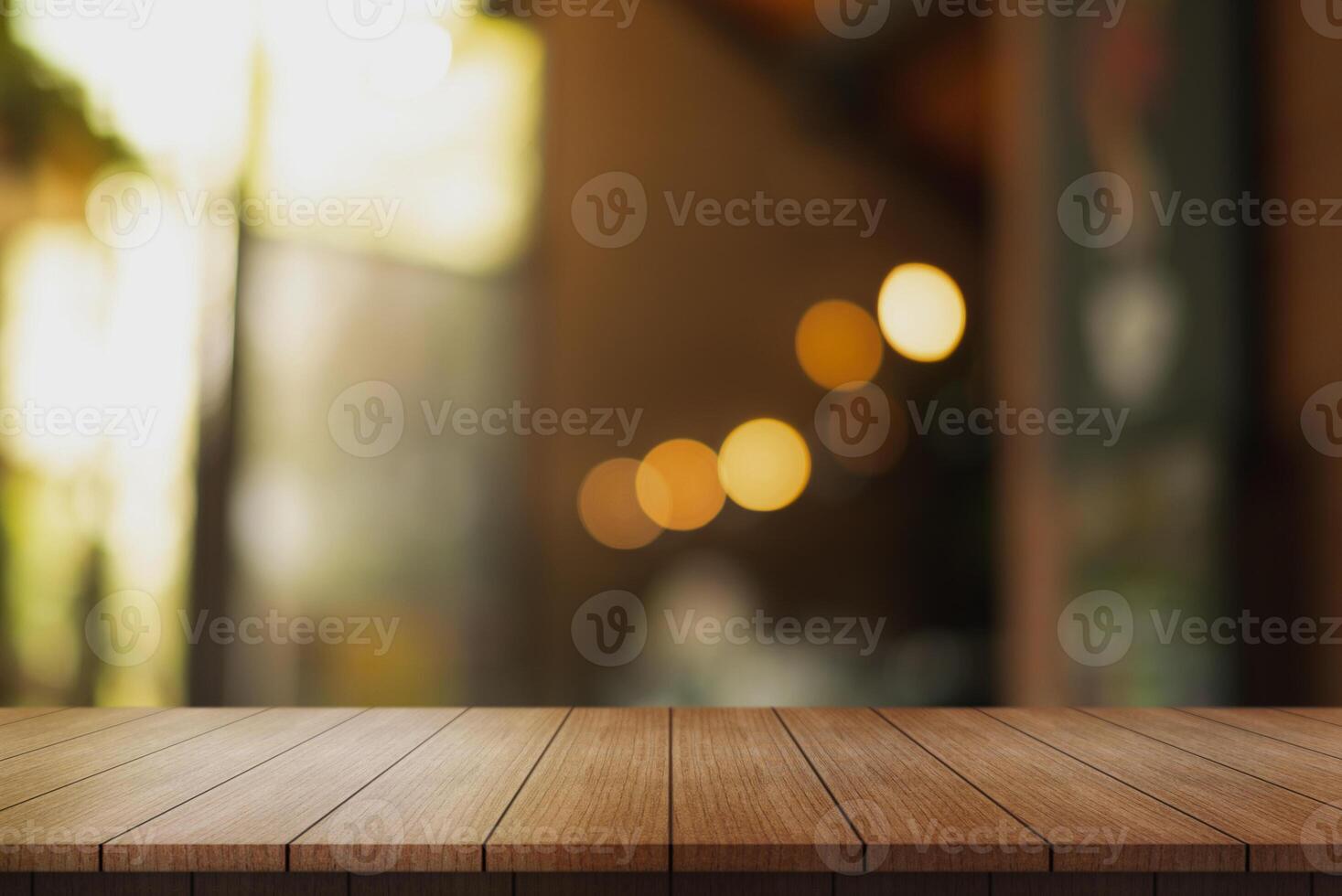 Empty wooden table top with lights bokeh on blur restaurant background. photo