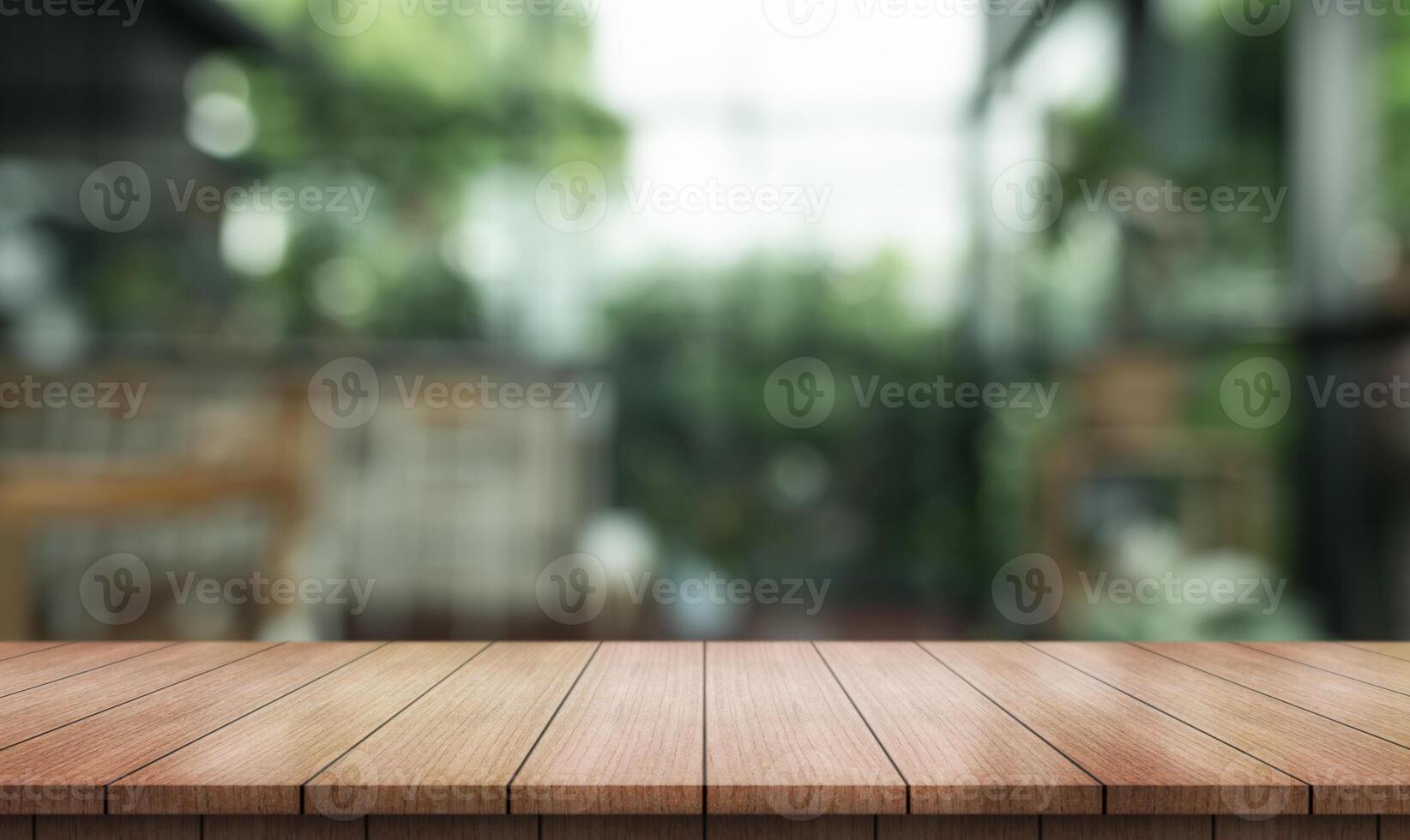 Empty wooden table top with lights bokeh on blur restaurant background photo