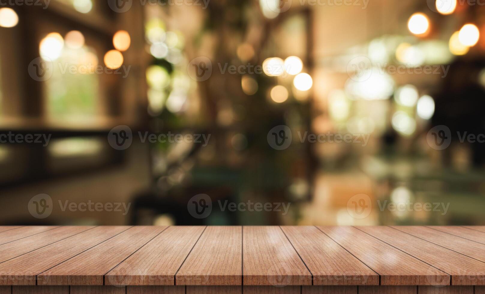 Empty wooden table top with lights bokeh on blur restaurant background. photo