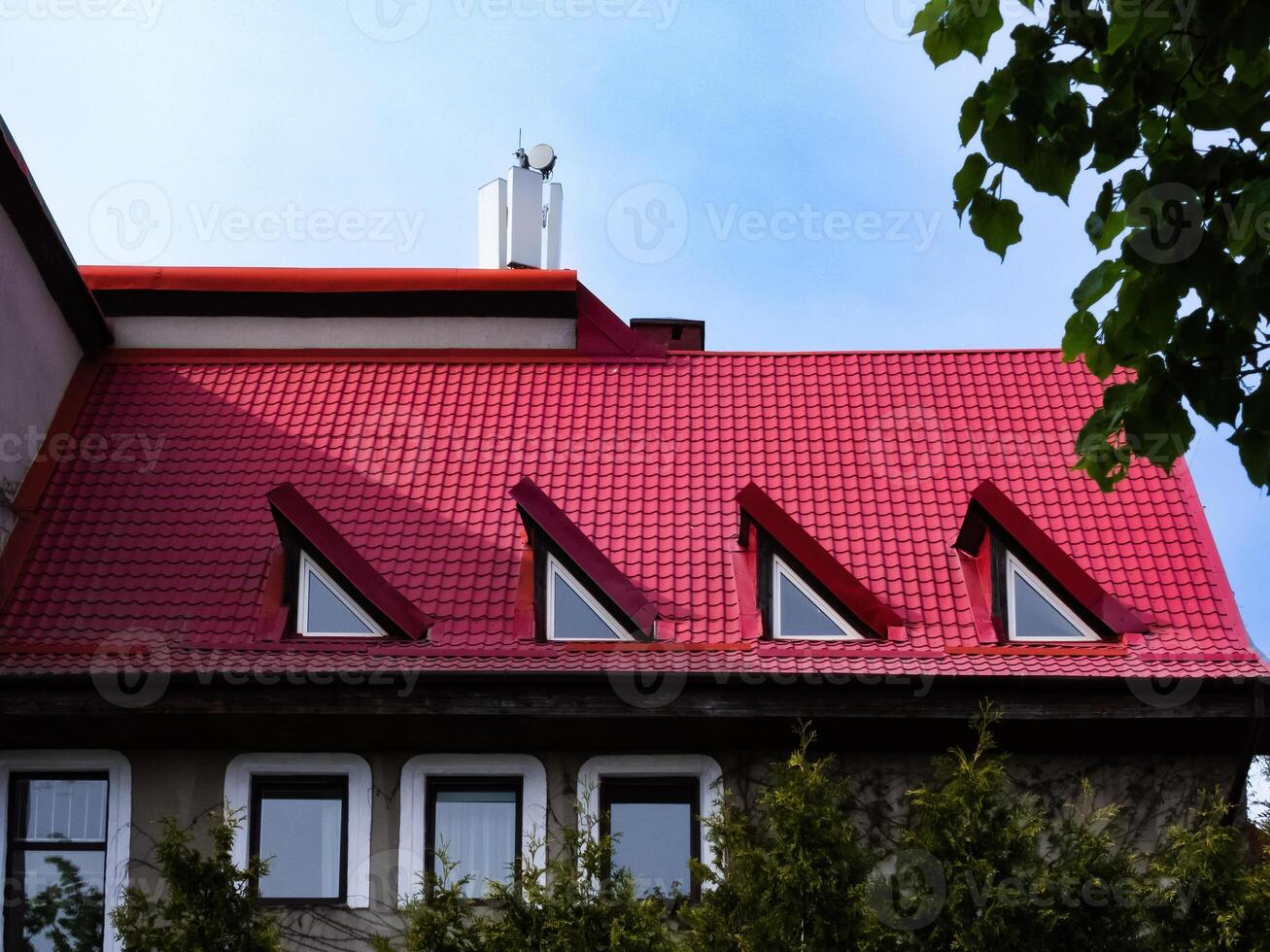 red tiled roof with triangular windows photo