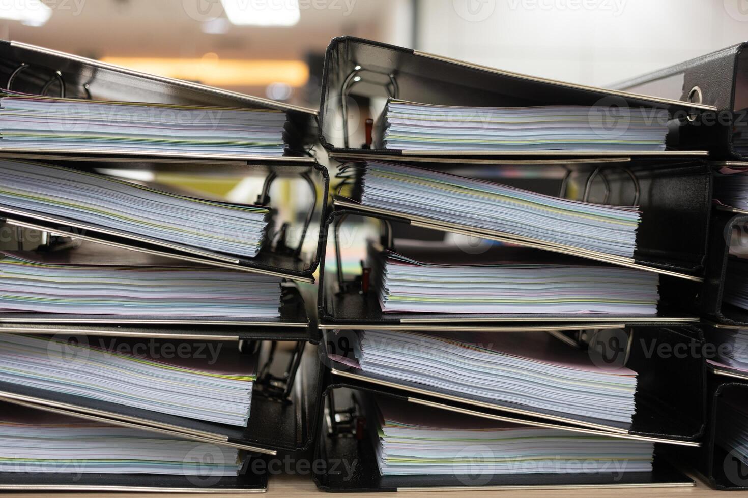 Files stacked on filing cabinet. Overflowing with documentation photo