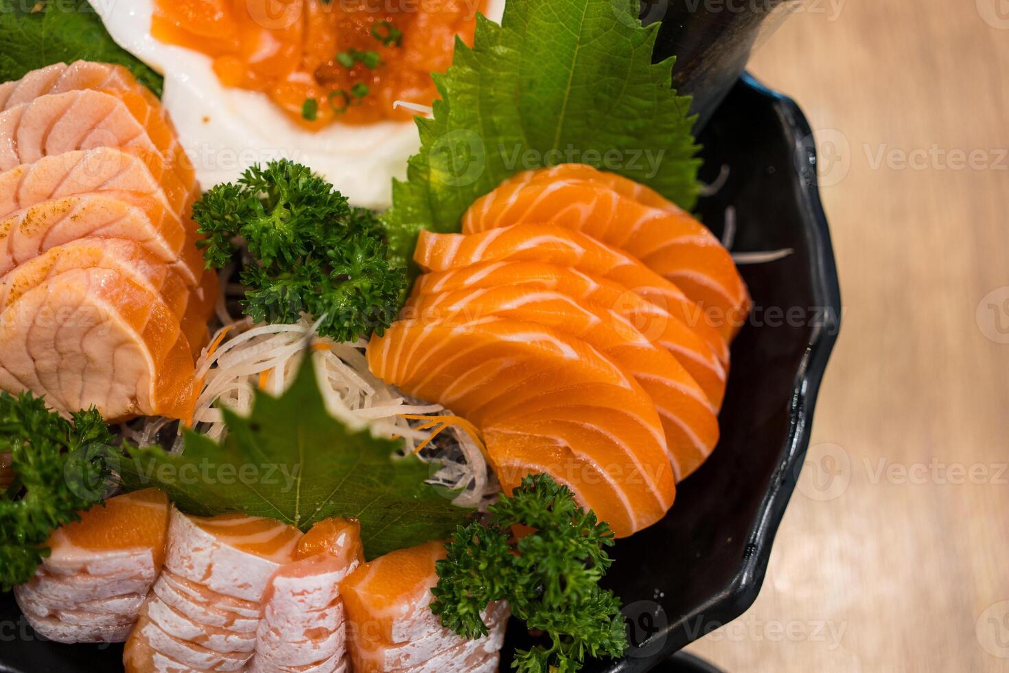 Salmon sashimi included orange with white stripe belly served on big bowl on ice photo